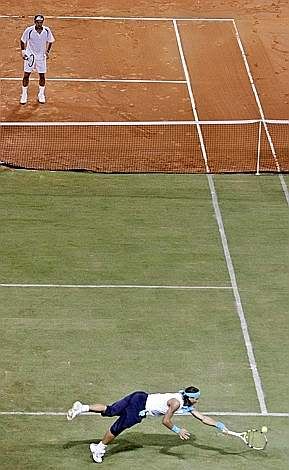 12. TENNIS - Nadal on grass, Federer on clay during their May split-court exhibition match in Mallorca, Spain.